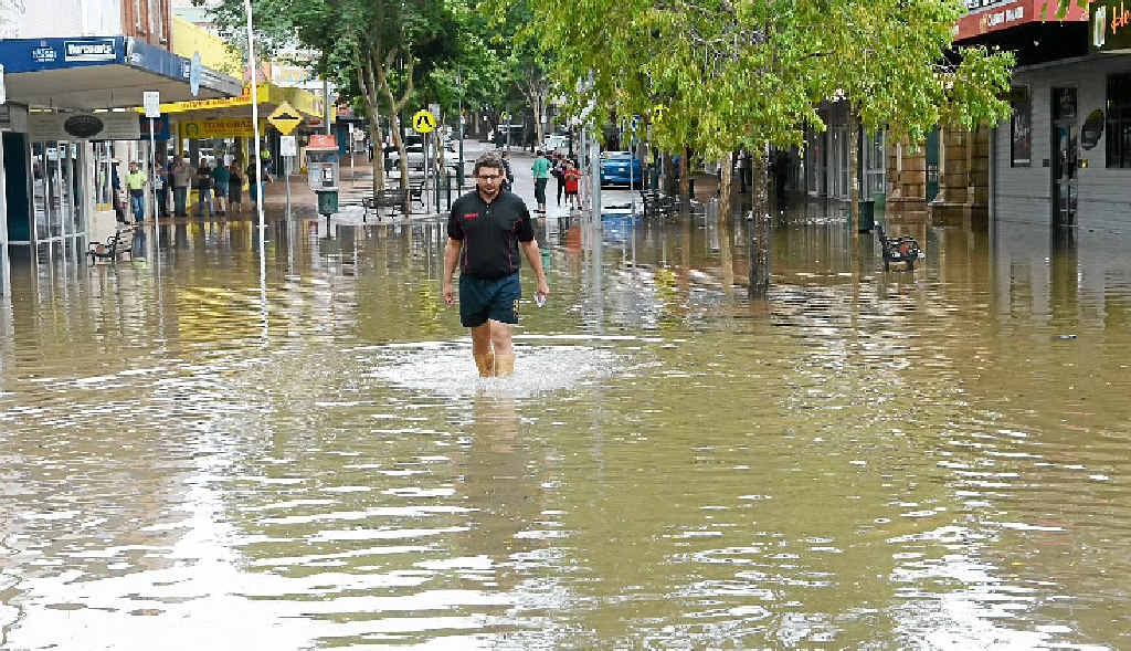Mary St business owner Peter Kross walks from his flooded business before the last flood clean up. Mary St business owner Peter Kross walks from his flooded business before the last flood clean up.
