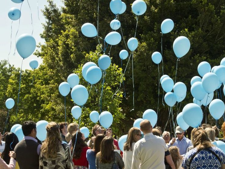 Light blue balloons are released at an emotional public memorial service for Lochlain Atkinson, who died when struck by a garbage truck.
