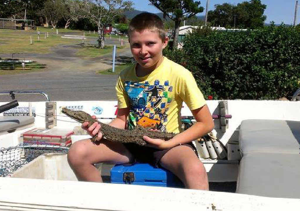 SMILING AT A CROCODILE: Brendan Reed with the croc he caught in Coorooman Creek on Saturday. SMILING AT A CROCODILE: Brendan Reed with the croc he caught in Coorooman Creek on Saturday.
