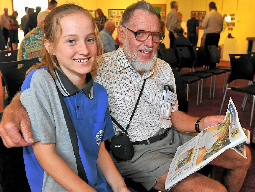 FUN HISTORY LESSON: Year 8 student Mia Hornby looking at the new publication with Ken Whittaker. FUN HISTORY LESSON: Year 8 student Mia Hornby looking at the new publication with Ken Whittaker.