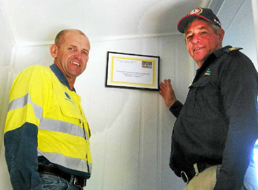 TRAINING BOOST: Bechtel’s Chris Short with Curtis Island Rural Fire Brigade’s Alan Smith with a plaque recognising Bechtel’s support for the brigade. TRAINING BOOST: Bechtel’s Chris Short with Curtis Island Rural Fire Brigade’s Alan Smith with a plaque recognising Bechtel’s support for the brigade.