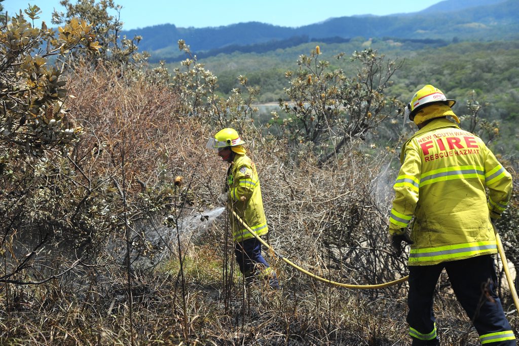 Sawtell firefighters Allen Gatenby and Mick Gibbons battle the fire on Boambee Headland. Sawtell firefighters Allen Gatenby and Mick Gibbons battle the fire on Boambee Headland.
