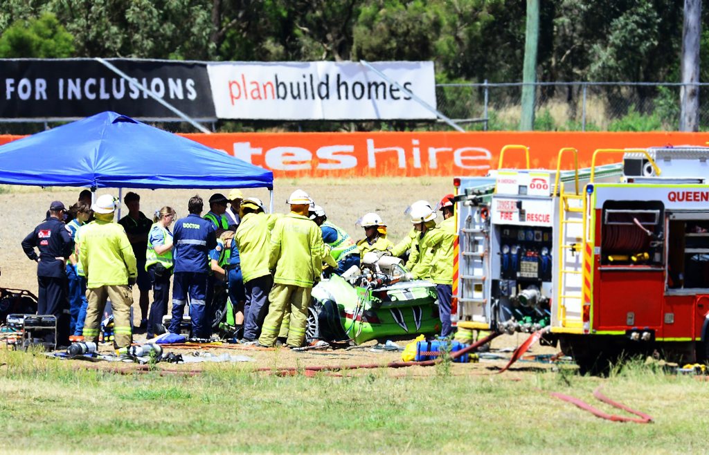 DESPERATE STRUGGLE: Firefighters and paramedics try to rescue the sole survivor of a crash after a private lap session at Queensland Raceway went tragically wrong on Tuesday. DESPERATE STRUGGLE: Firefighters and paramedics try to rescue the sole survivor of a crash after a private lap session at Queensland Raceway went tragically wrong on Tuesday.