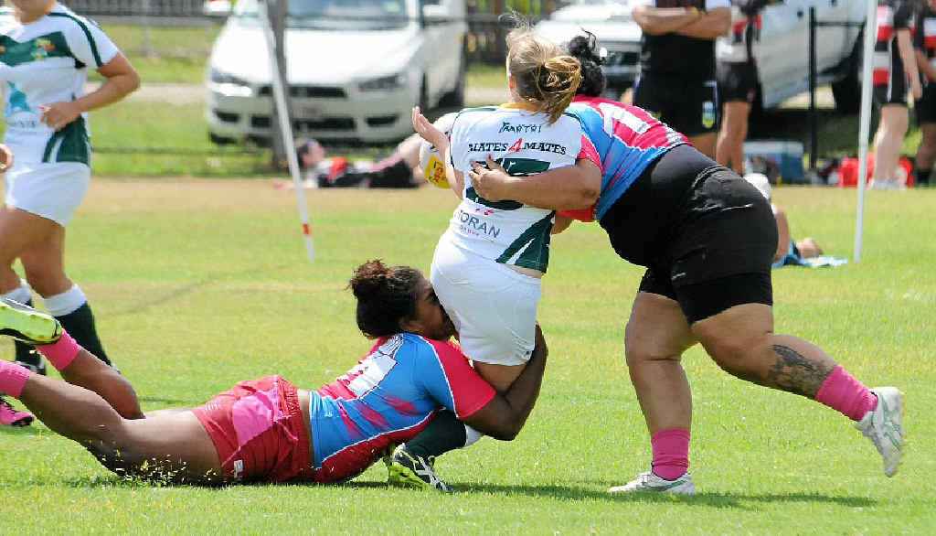 WRAPPED UP: Emma Blanch (No 15 with the ball) from Tribe Sevens is tackled top and bottom by players from The Nations at the Byron Rugby Sevens. WRAPPED UP: Emma Blanch (No 15 with the ball) from Tribe Sevens is tackled top and bottom by players from The Nations at the Byron Rugby Sevens.