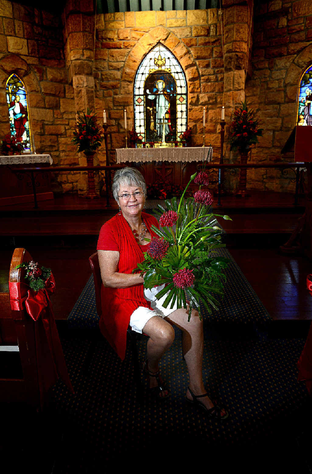 AT RIGHT: Co-ordinator of the St Bartholomew’s Floral Group with “The Colour of Love” floral display at St Bartholomew’s Anglican Church. AT RIGHT: Co-ordinator of the St Bartholomew’s Floral Group with “The Colour of Love” floral display at St Bartholomew’s Anglican Church.