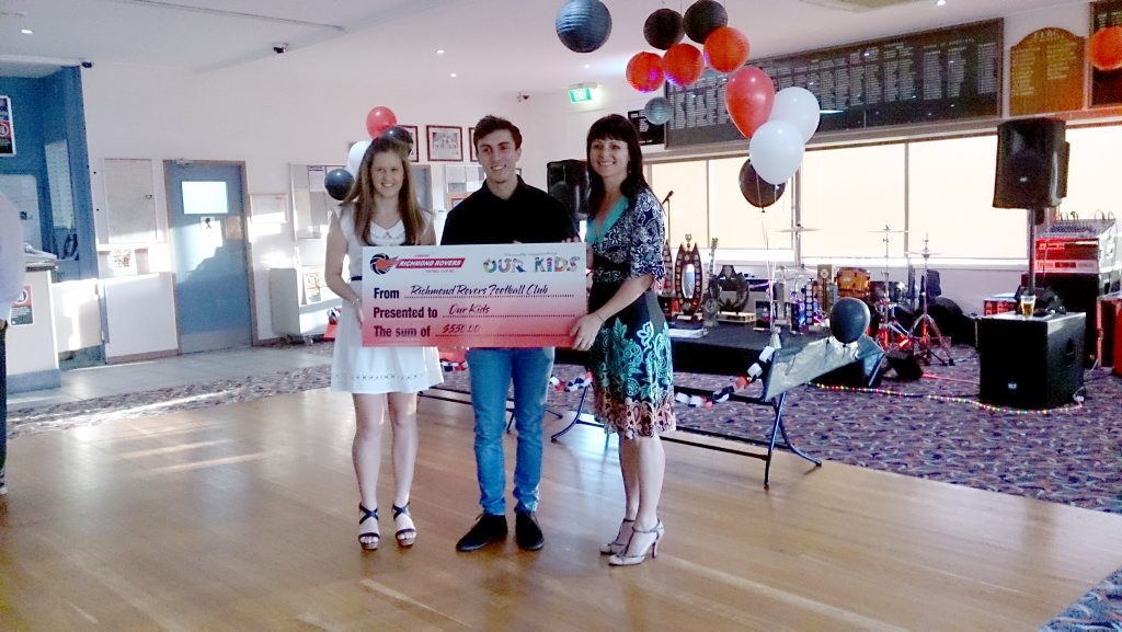 Ricmond Rovers Football Club players Abbie Heffernan and Jonathon Smee present a cheque to Rebekka Battista from Our Kids. Ricmond Rovers Football Club players Abbie Heffernan and Jonathon Smee present a cheque to Rebekka Battista from Our Kids.