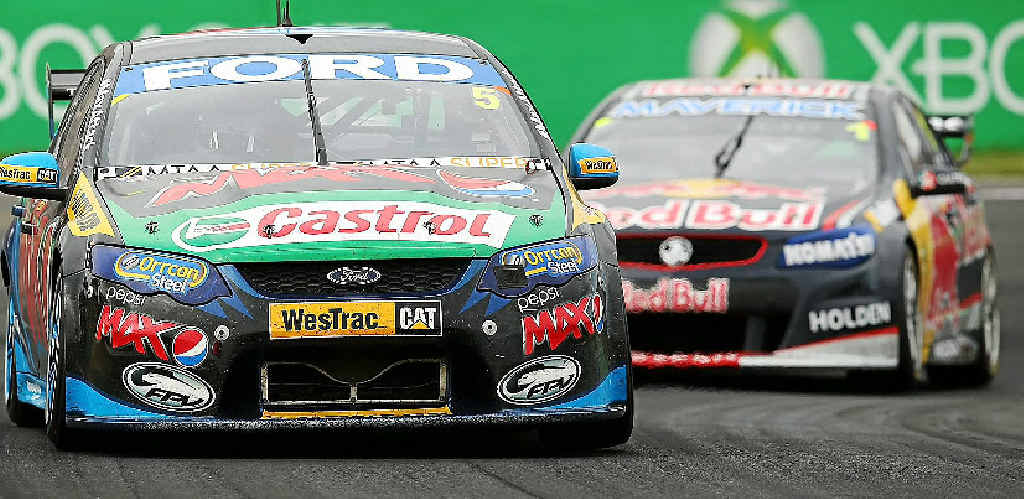 WINNING FEELING: Mark Winterbottom (pictured below celebrating his victory) is chased by Jamie Whincup during the Bathurst 1000. Photo: Getty Images. WINNING FEELING: Mark Winterbottom (pictured below celebrating his victory) is chased by Jamie Whincup during the Bathurst 1000. Photo: Getty Images.