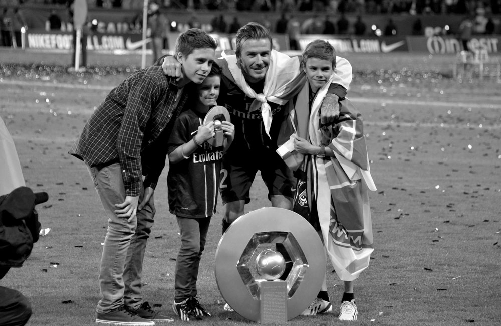 David Beckham with his sons after PSG's league win David Beckham with his sons after PSG's league win
