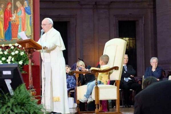 The little boy takes a seat in the Pope's chair. The little boy takes a seat in the Pope's chair.