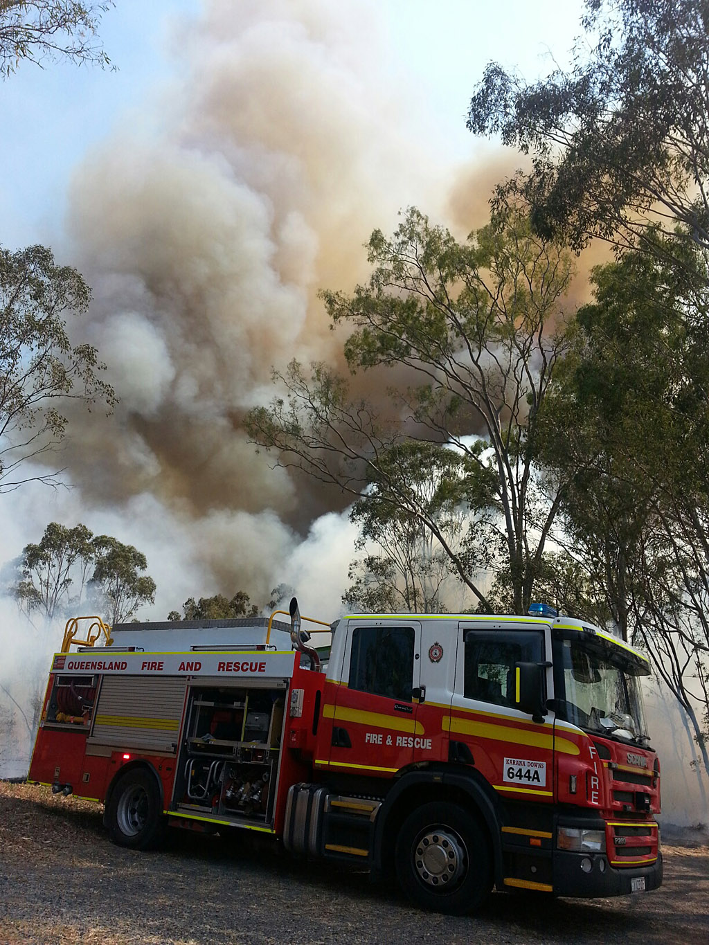 A fire crew at the scene of a large grass fire burning near High Street in Bundamba. A fire crew at the scene of a large grass fire burning near High Street in Bundamba.