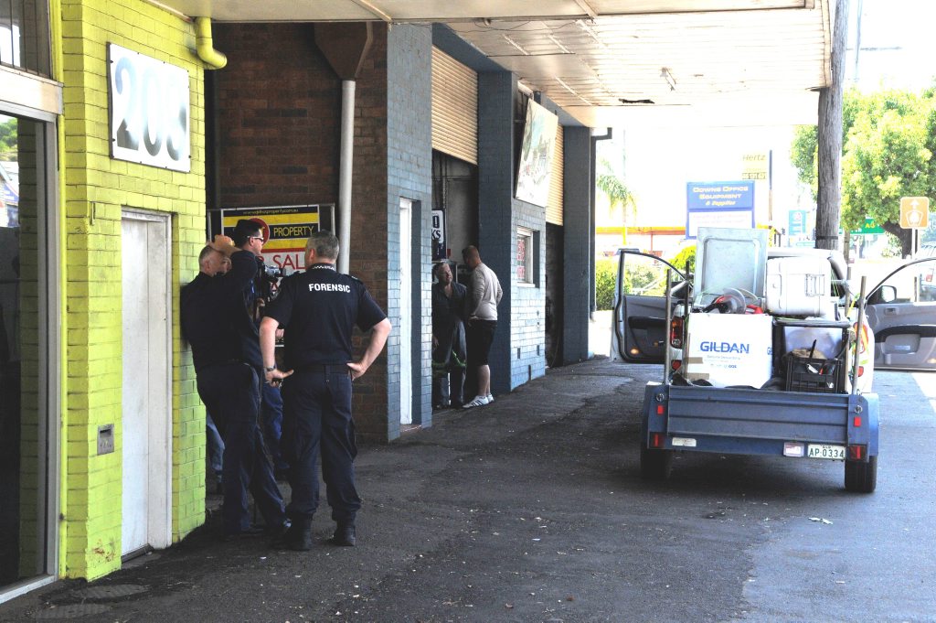 A police forensics team supervises as a Life and Death Motorcycle Club associate collects belongings from the outlawed gang’s James St premises in November. A police forensics team supervises as a Life and Death Motorcycle Club associate collects belongings from the outlawed gang’s James St premises in November.