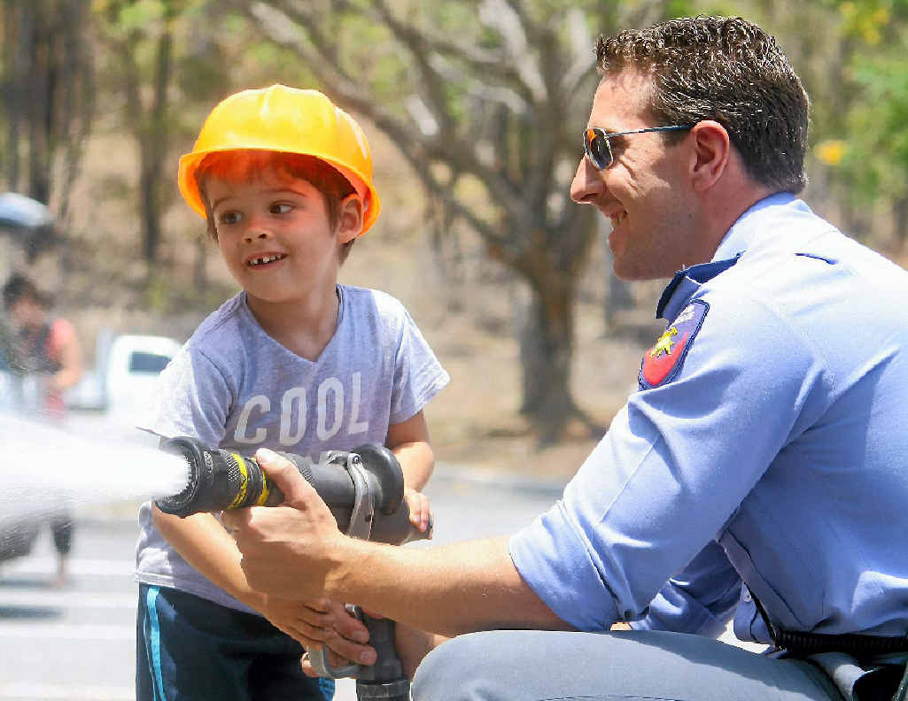 PLAY TIME: William Ross, 3, enjoys the visit from Gladstone Fire Brigade on Wednesday, with firefighter Adam Hollier. PLAY TIME: William Ross, 3, enjoys the visit from Gladstone Fire Brigade on Wednesday, with firefighter Adam Hollier.