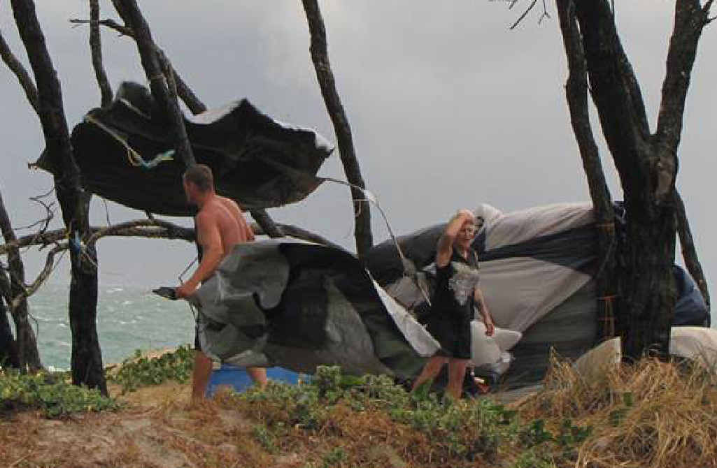 SCARY STUFF: Campers at Inskip Point struggle to keep hold of their tent as it almost blows away in high winds on Saturday. SCARY STUFF: Campers at Inskip Point struggle to keep hold of their tent as it almost blows away in high winds on Saturday.
