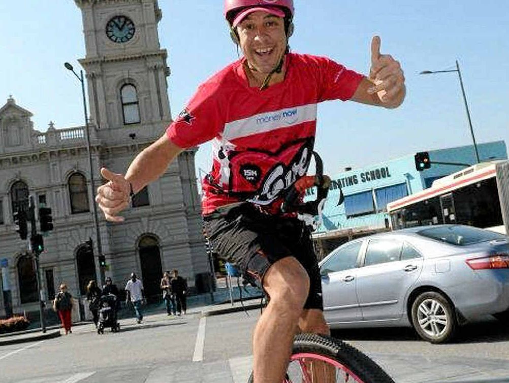 ON A MISSION: Samuel Johnson unicycling through Tenterfield and Stanthorpe on his 15,000km trip to raise awareness about breast cancer. PHOTO: CONTRIBUTED