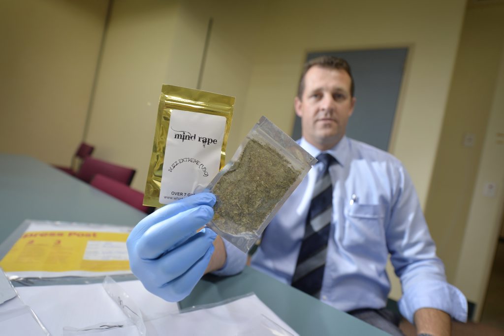 Gladstone CIB Detective Senior Sergeant Luke Peachey with packages of synthetic cannabis that have been seized by detectives over the past few weeks. Gladstone CIB Detective Senior Sergeant Luke Peachey with packages of synthetic cannabis that have been seized by detectives over the past few weeks.