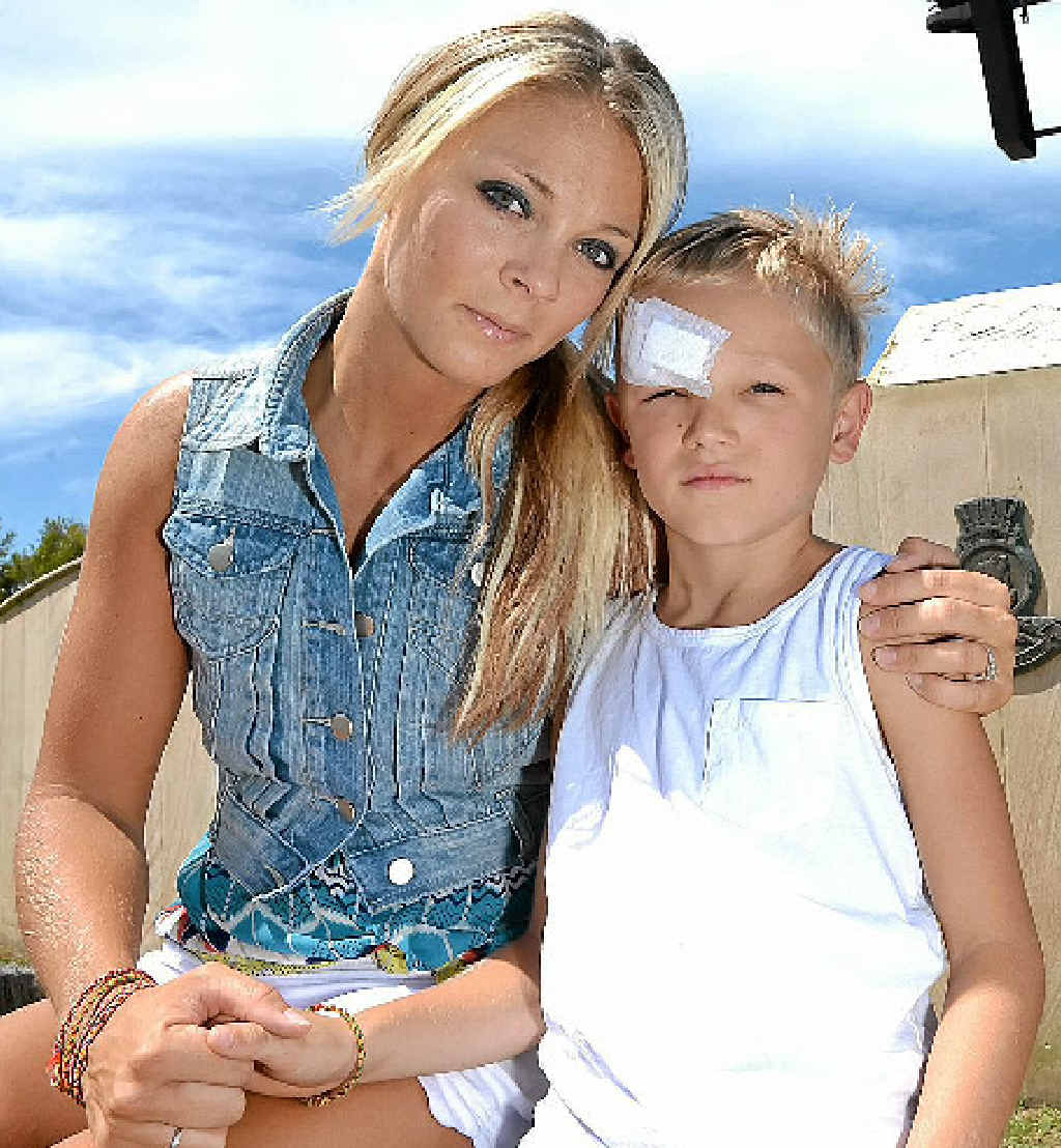 SORE AND SORRY: Seven-year-old Dre Conquest with his mother Elise at the HMAS Brisbane memorial lookout. SORE AND SORRY: Seven-year-old Dre Conquest with his mother Elise at the HMAS Brisbane memorial lookout.