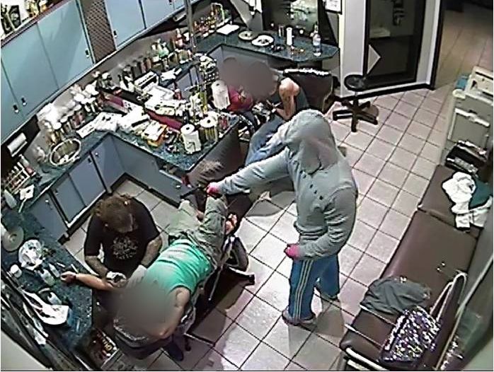Supplied image obtained Sunday, Nov. 24, 2013, taken from CCTV footage showing the moments before a Sydney tattoo artist was shot dead. The footage shows two men, who had their faces disguised by hoods and bandannas, walk into the studio via a rear entrance on the night of March 26, 2011. The 40-year-old tattoo artist died after being shot in the shoulder at the Pretty In Ink tattoo parlour in Wes Supplied image obtained Sunday, Nov. 24, 2013, taken from CCTV footage showing the moments before a Sydney tattoo artist was shot dead. The footage shows two men, who had their faces disguised by hoods and bandannas, walk into the studio via a rear entrance on the night of March 26, 2011. The 40-year-old tattoo artist died after being shot in the shoulder at the Pretty In Ink tattoo parlour in Wes