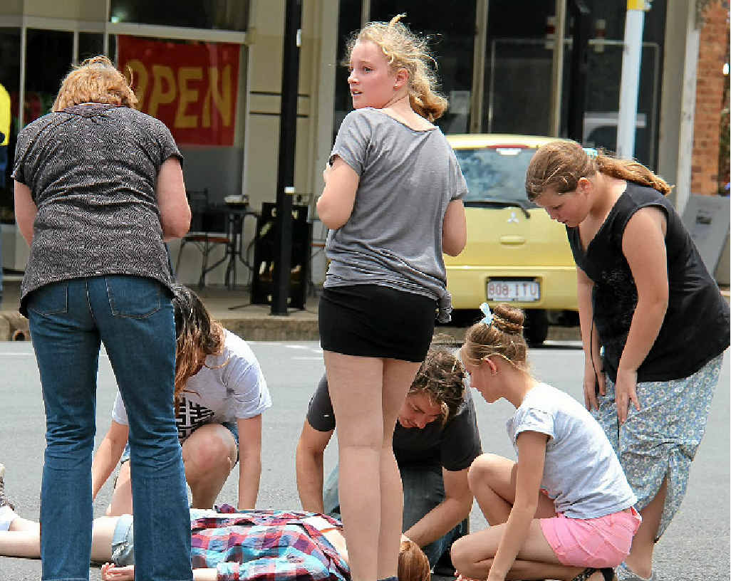 Actors and extras rehearse the crash scene before the cameras start to roll.