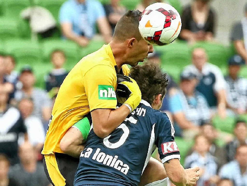 OUCH: Mark Birighitti collides with Victory captain Mark Milligan. OUCH: Mark Birighitti collides with Victory captain Mark Milligan.