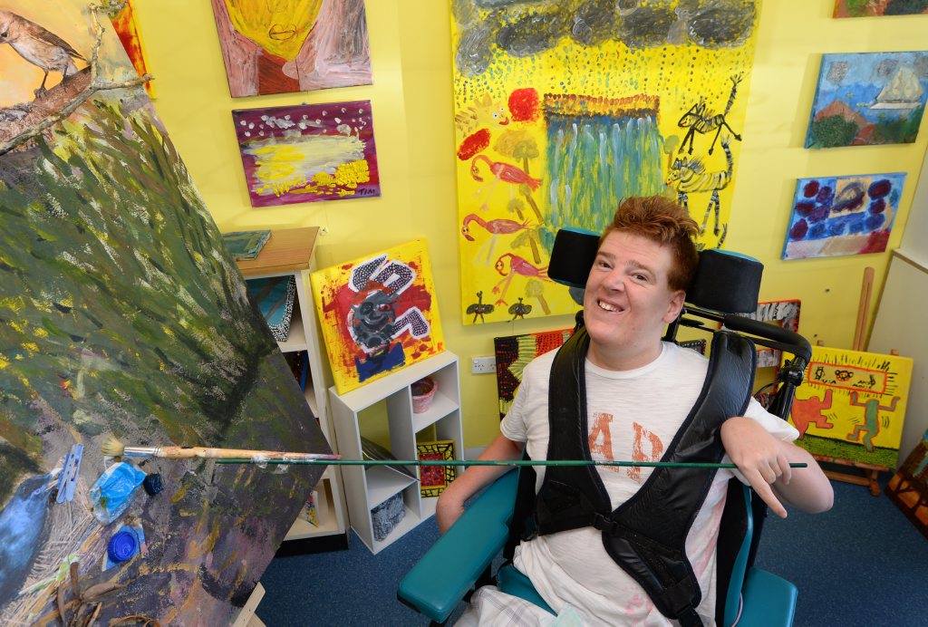 David Whittaker has not let Cerebral Palsy stop him from putting paintbrush to canvas to produce his art. David's paintings can soon be seen at the Multicap Exhibition. Photo: Chris Ison / The Morning Bulletin David Whittaker has not let Cerebral Palsy stop him from putting paintbrush to canvas to produce his art. David's paintings can soon be seen at the Multicap Exhibition. Photo: Chris Ison / The Morning Bulletin