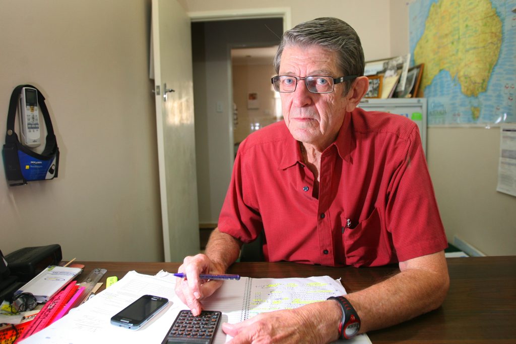 Retired electricity industry worker John Blanchfield cruches the numbers on the electricity price hike. Photo: Chris Ison / The Morning Bulletin Retired electricity industry worker John Blanchfield cruches the numbers on the electricity price hike. Photo: Chris Ison / The Morning Bulletin