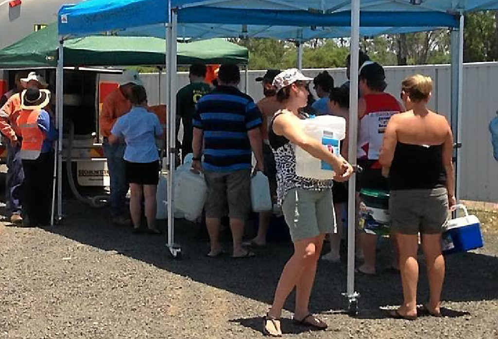 Dysart residents collect water from Isaac Regional Council drop-off zones after the town’s supply was cut off. Dysart residents collect water from Isaac Regional Council drop-off zones after the town’s supply was cut off.