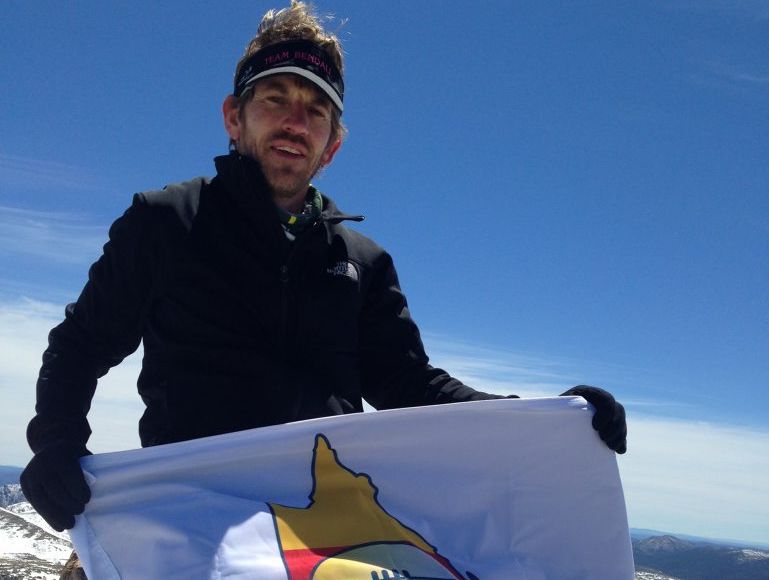Gavin Bendall celebrates with the CQ NRL Bid flag at Australia's highest point after reaching the top of Mount Kosciuszko during the 2013 Coast to Kosciuszko Ultra Marathon. Gavin Bendall celebrates with the CQ NRL Bid flag at Australia's highest point after reaching the top of Mount Kosciuszko during the 2013 Coast to Kosciuszko Ultra Marathon.