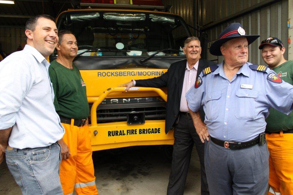 Queensland Emergency Volunteers Assistant Minister Ted Malone (from Sarina - in navy suit) and Rural Fire Brigade Association president Mike Garrahy (from Toowoomba - blue uniform on right) meeting with rural firefighters. Photo: Contributed Queensland Emergency Volunteers Assistant Minister Ted Malone (from Sarina - in navy suit) and Rural Fire Brigade Association president Mike Garrahy (from Toowoomba - blue uniform on right) meeting with rural firefighters. Photo: Contributed