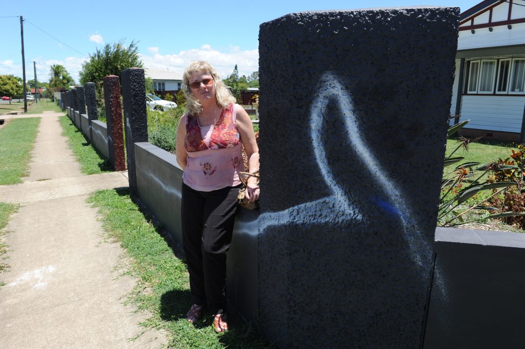 COMMUNITY VANDALISM: Branyan Street resident Anette Boles is upset that vandals have sprayed her fence with paint. Photo: Mike Knott / NewsMail COMMUNITY VANDALISM: Branyan Street resident Anette Boles is upset that vandals have sprayed her fence with paint. Photo: Mike Knott / NewsMail