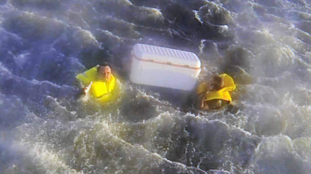 AT LAST: John Lynch and Paul Maher clinging to their esky after they were found floating off the Clarence Coast on Saturday morning. Photos: Westpac Rescue Helicopter AT LAST: John Lynch and Paul Maher clinging to their esky after they were found floating off the Clarence Coast on Saturday morning. Photos: Westpac Rescue Helicopter