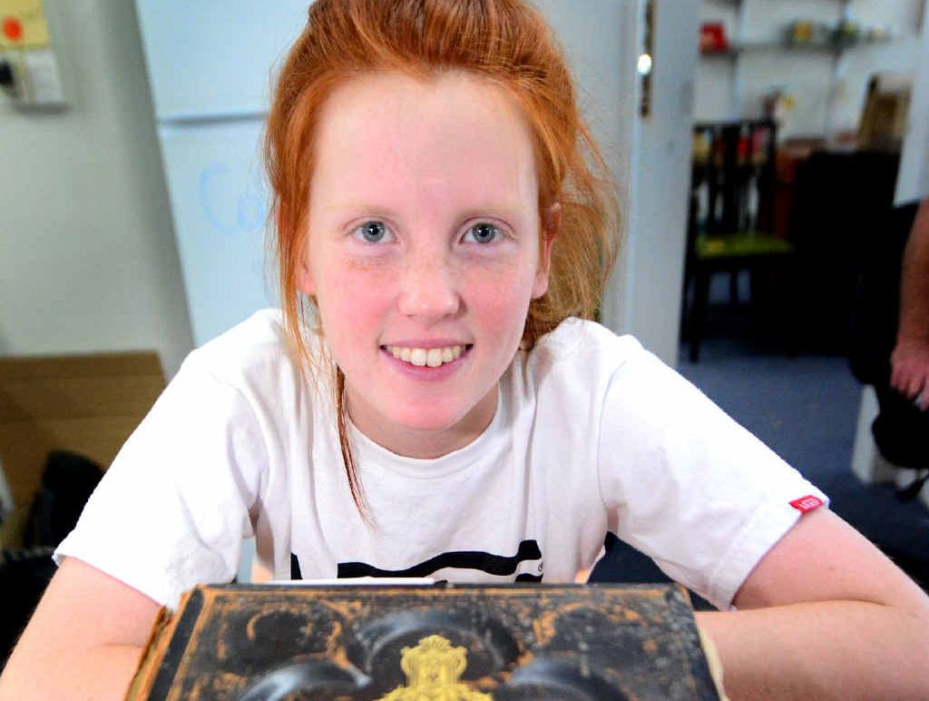 Jordyn Witt at the Fair Dinkum Tender Centre with a Bible, dated 1883, one of the many items for sale. Jordyn Witt at the Fair Dinkum Tender Centre with a Bible, dated 1883, one of the many items for sale.