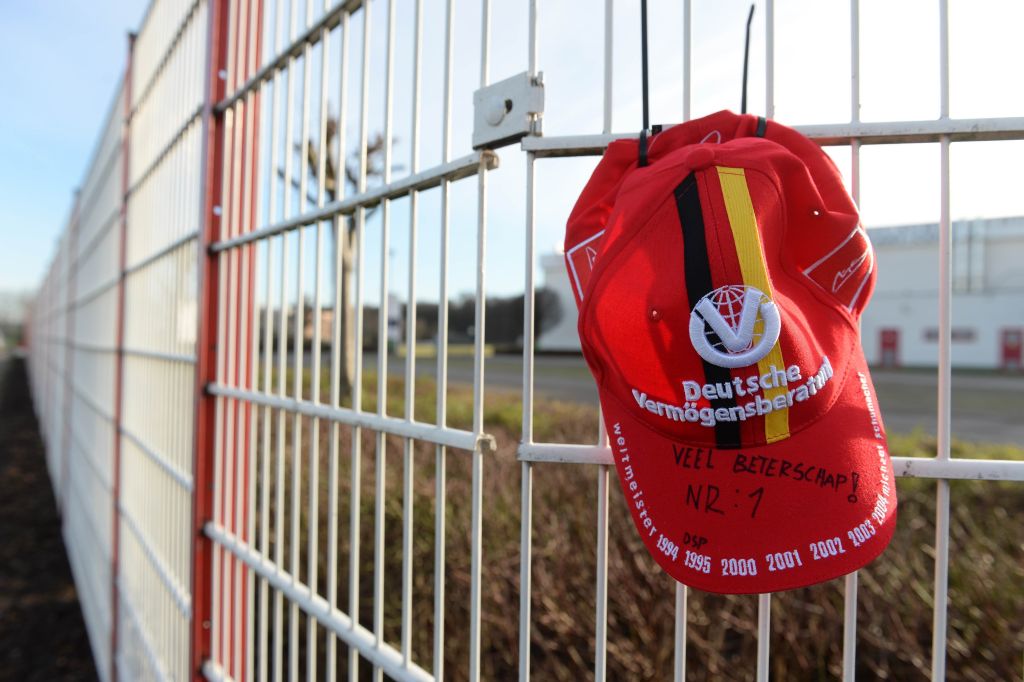 A fan's cap hangs on the fence of the karting circuit owned by German former Formula One champion Michael Schumacher. A fan's cap hangs on the fence of the karting circuit owned by German former Formula One champion Michael Schumacher.