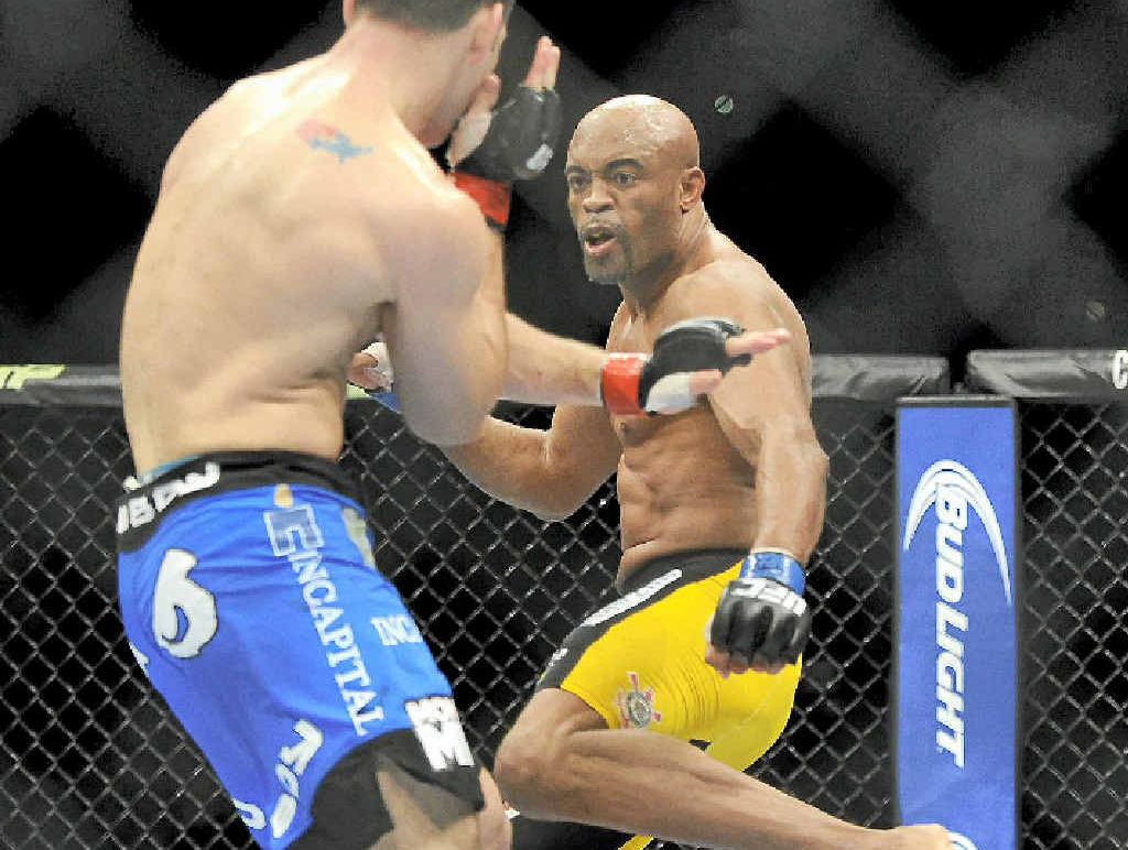 HURT: Anderson Silva (right) prepares to kick Chris Weidman in their fight in Las Vegas. HURT: Anderson Silva (right) prepares to kick Chris Weidman in their fight in Las Vegas.