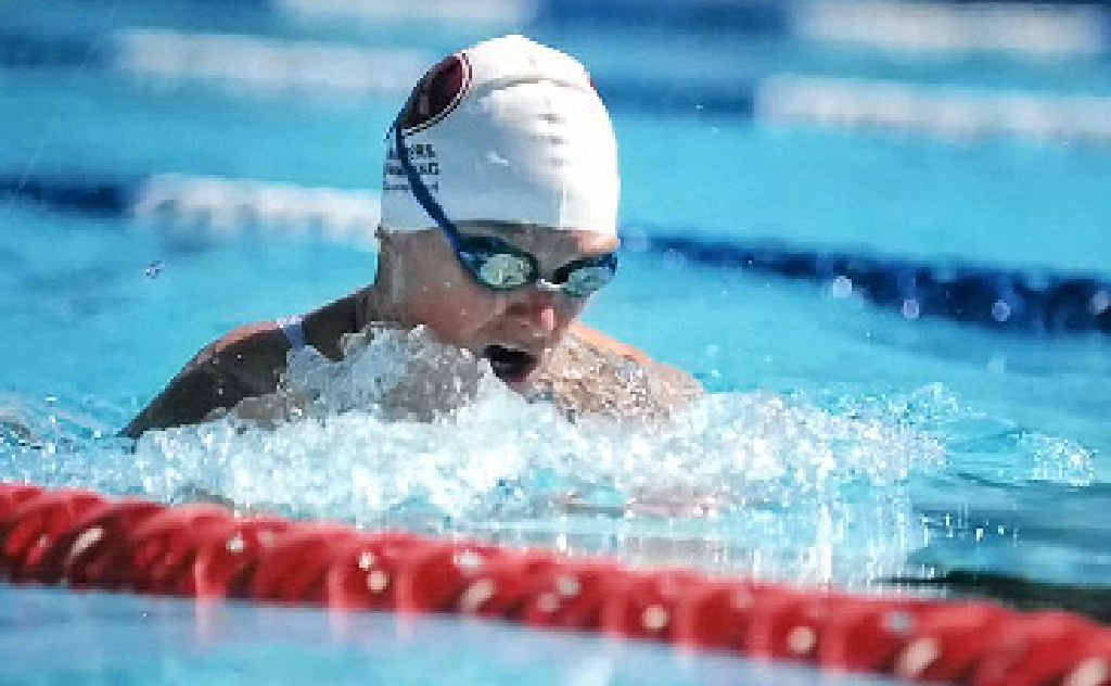 POWERING ON: Therese Crollick gets some indoor training for Sunday’s Evans Heads Ocean Swim and (below) in action at Ballina’s Shaws Bay. POWERING ON: Therese Crollick gets some indoor training for Sunday’s Evans Heads Ocean Swim and (below) in action at Ballina’s Shaws Bay.
