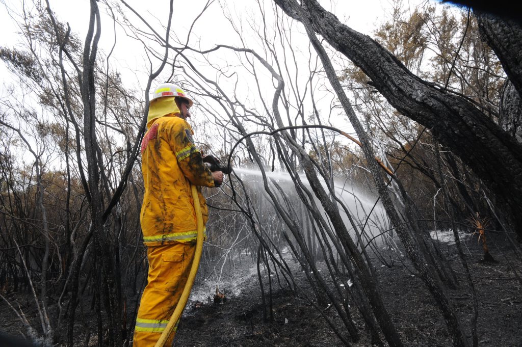 Clunes RFS Fire fighter Steven Battistuzzi Putting out a spotm Fire at the Lennox Head fires on Tuesday. Photo Doug Eaton / The Northern Star Clunes RFS Fire fighter Steven Battistuzzi Putting out a spotm Fire at the Lennox Head fires on Tuesday. Photo Doug Eaton / The Northern Star
