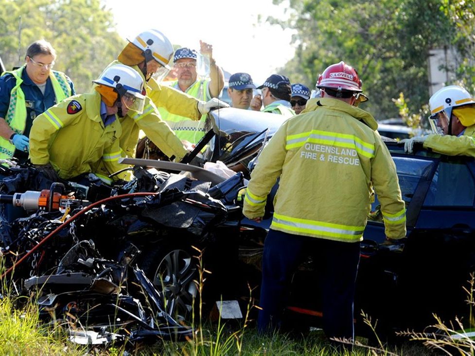 Emergency service crews work to remove driver Jade Scrim after a four-vehicle crash near Dundathu left her trapped. Emergency service crews work to remove driver Jade Scrim after a four-vehicle crash near Dundathu left her trapped.