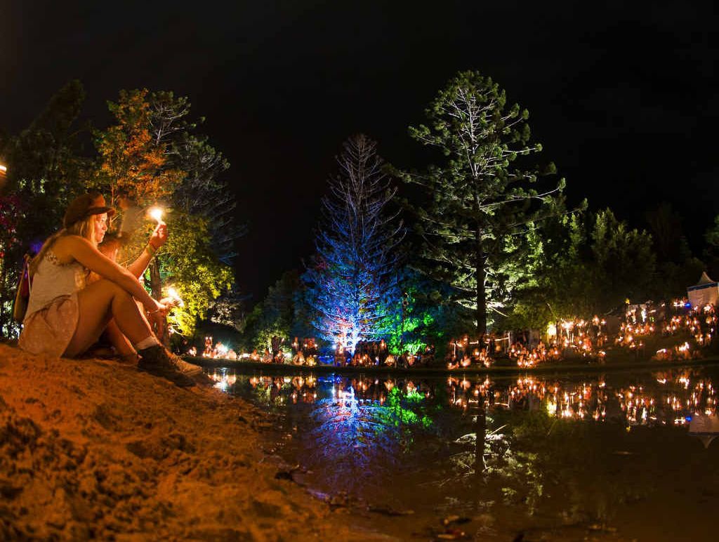 ENLIGHTENED: The amphitheatre is lit by thousands of people holding candles for the popular fire event to end the Woodford Folk Festival. ENLIGHTENED: The amphitheatre is lit by thousands of people holding candles for the popular fire event to end the Woodford Folk Festival.