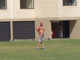 A man holds a knife to his chest at Nelson Park, Alexandra Headland. A man holds a knife to his chest at Nelson Park, Alexandra Headland.