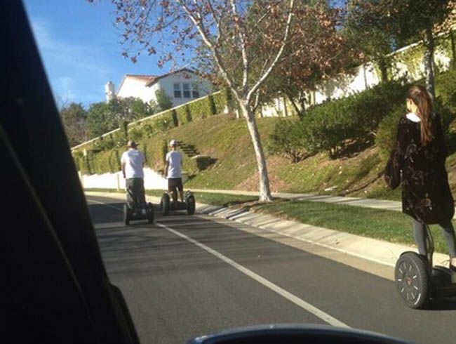 Justine Bieber and Selena Gomez riding Segways together. Justine Bieber and Selena Gomez riding Segways together.