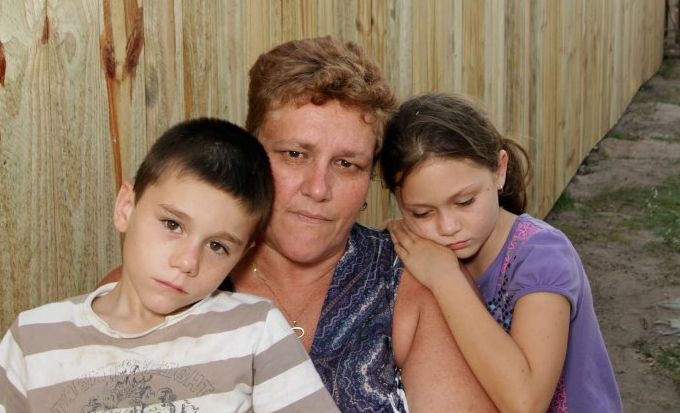 Tania Bell with her grandchildren Adam, 7, and Ammy, 8, are struggling to come to terms with the council putting down their dog, Tara. Pictured in the background is the fence the council asked Tania to build to keep Tara in. Tania Bell with her grandchildren Adam, 7, and Ammy, 8, are struggling to come to terms with the council putting down their dog, Tara. Pictured in the background is the fence the council asked Tania to build to keep Tara in.