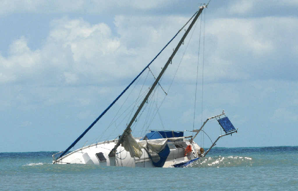 The incoming tide washes over the yacht, which became caught on a reef near Cape Hillsborough. A high tide and strong winds pushed it further onto the rocks, puncturing its hull. The incoming tide washes over the yacht, which became caught on a reef near Cape Hillsborough. A high tide and strong winds pushed it further onto the rocks, puncturing its hull.