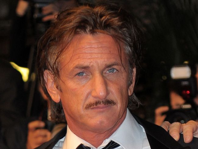 Sean Penn hindered by the paparazzi in Los Angeles.