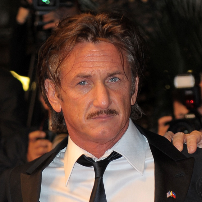 Sean Penn hindered by the paparazzi in Los Angeles. Sean Penn hindered by the paparazzi in Los Angeles.