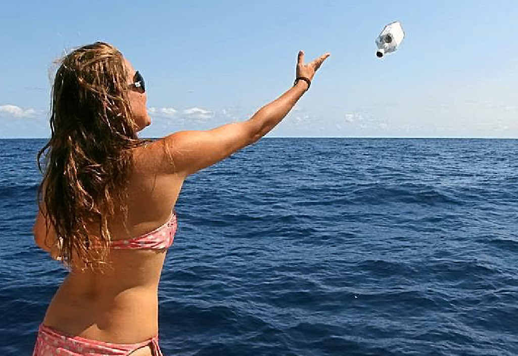 A member of the sailing group launches the bottle into the ocean in October 2012. A member of the sailing group launches the bottle into the ocean in October 2012.