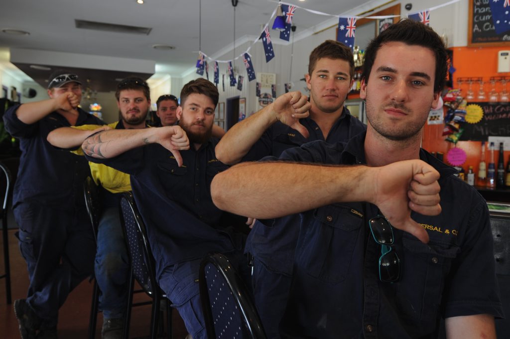 Nick Grieves and workmates give a big thumbs down to the person who stole the Australian flag from the Lamington Hotel. Nick Grieves and workmates give a big thumbs down to the person who stole the Australian flag from the Lamington Hotel.