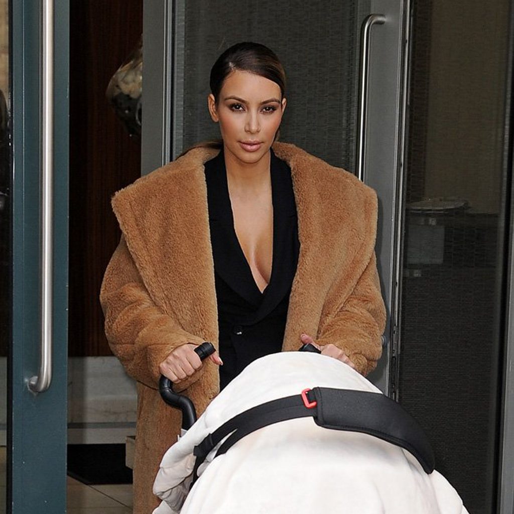 Smiling mom Kim Kardashian walks out with baby North whom she wants to walk down the isle with her stepfather Bruce Jenner. Smiling mom Kim Kardashian walks out with baby North whom she wants to walk down the isle with her stepfather Bruce Jenner.