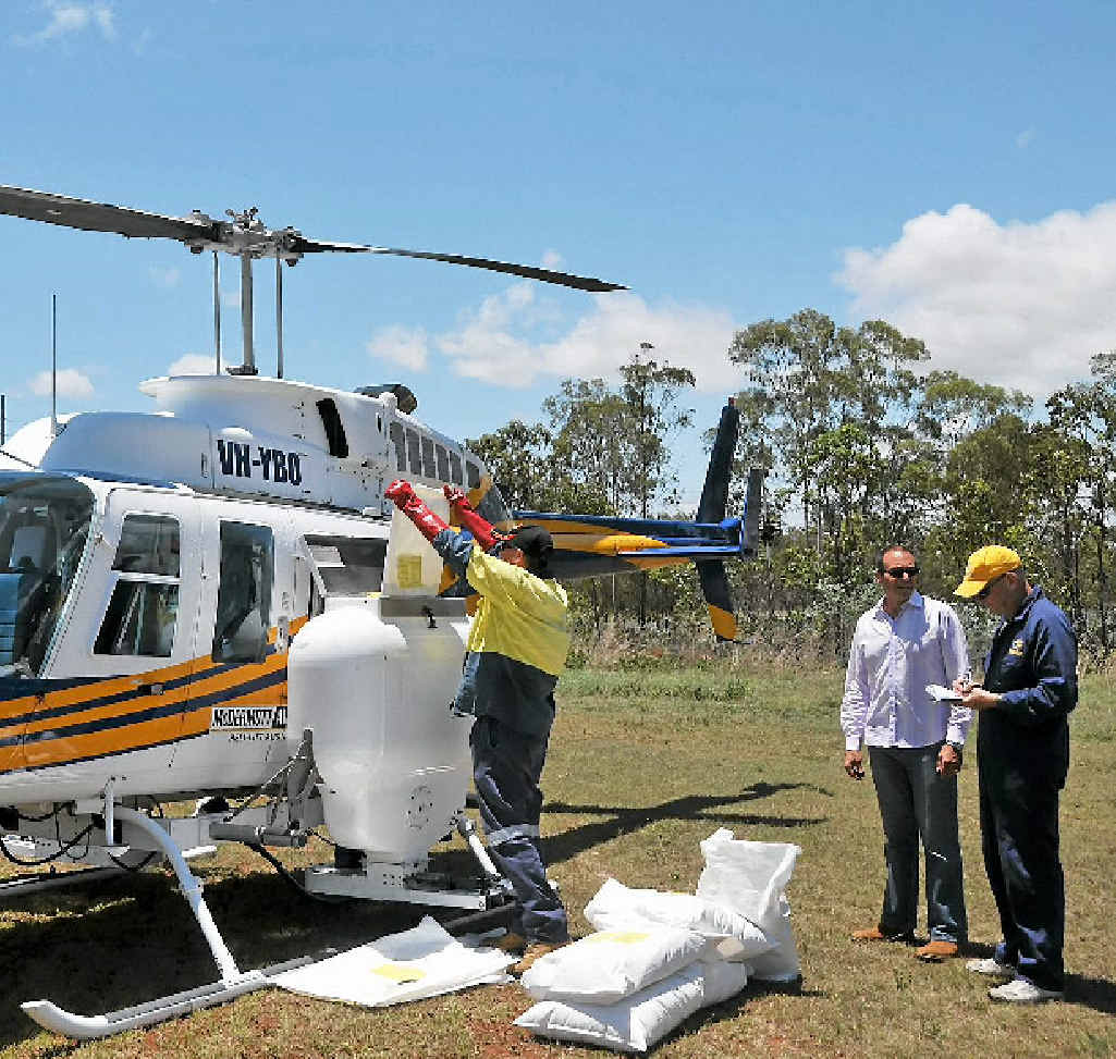 STERILISED ANTS: Clint Mason loads the chopper with fire ant bait to spread throughout the Yarwun area. STERILISED ANTS: Clint Mason loads the chopper with fire ant bait to spread throughout the Yarwun area.