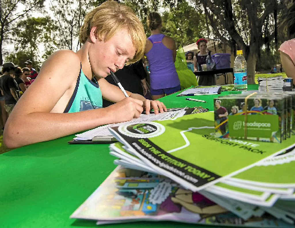 CITY IN NEED: Cody Emmerton signs the Headspace petition during Australia Day celebrations at Gladstone Marina. CITY IN NEED: Cody Emmerton signs the Headspace petition during Australia Day celebrations at Gladstone Marina.