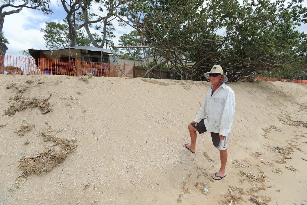 Graham Robinson from Maryborough takes a look at the sand pushed up in front of his caravan on the beachfront at Torquay Caravan park. Graham Robinson from Maryborough takes a look at the sand pushed up in front of his caravan on the beachfront at Torquay Caravan park.