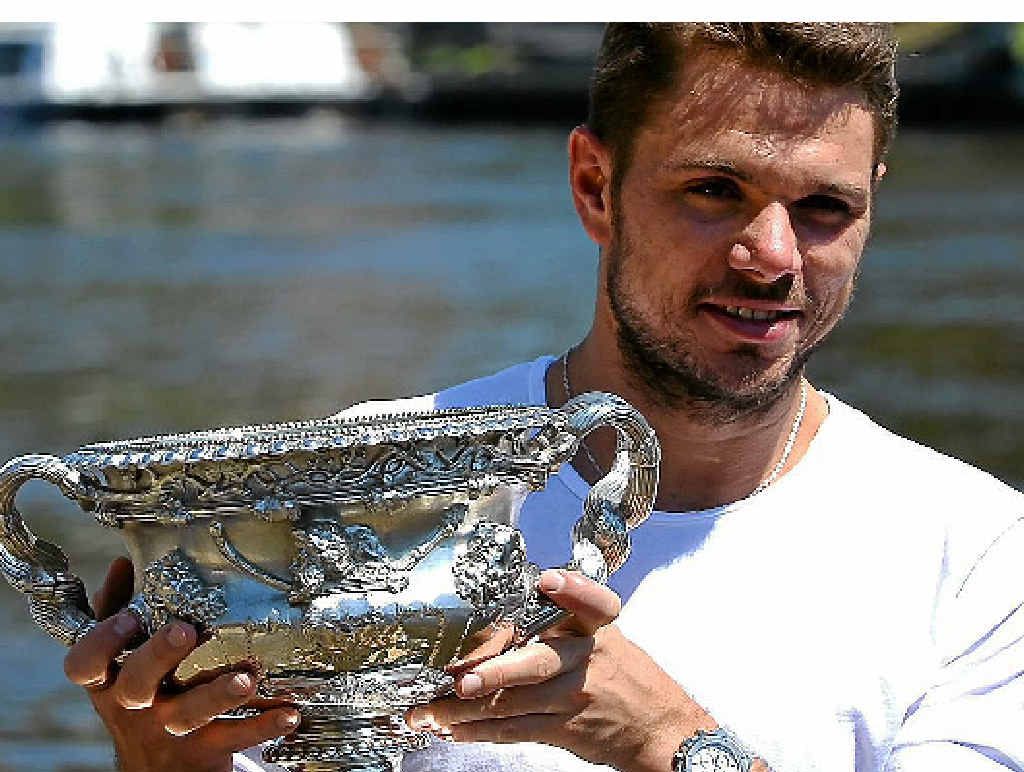 STAN AND DELIVER: Stanislas Wawrinka poses with the 2014 Australian Open winner’s trophy on the bank of the Yarra River in Melbourne. STAN AND DELIVER: Stanislas Wawrinka poses with the 2014 Australian Open winner’s trophy on the bank of the Yarra River in Melbourne.